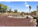 Fenced in backyard swimming pool with stone trim and desert landscaping at 3514 W Helena Dr, Glendale, AZ 85308
