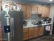 Updated kitchen with stainless steel refrigerator and ample cabinet space at 3830 W Cavalier Dr, Phoenix, AZ 85019