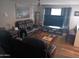 Open-concept living room with a comfortable leather sofa set and ceiling fan at 3830 W Cavalier Dr, Phoenix, AZ 85019