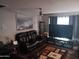 Comfortable living room featuring a plush leather sofa and entertainment center at 3830 W Cavalier Dr, Phoenix, AZ 85019
