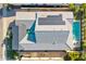 Aerial view of home featuring gray roof, solar panels, sparkling pool and lush landscaping at 3890 E Andalusia Ave, Gilbert, AZ 85298
