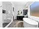 Spa-like bathroom featuring a modern soaking tub, glass-enclosed shower, and sleek vanity at 3890 E Andalusia Ave, Gilbert, AZ 85298