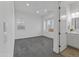 Bright bedroom featuring neutral walls, a cozy window seat, plush carpeting, and an adjacent bathroom at 3890 E Andalusia Ave, Gilbert, AZ 85298