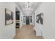 Elegant entryway featuring herringbone floors, designer lighting, and a beverage center for sophisticated living at 3890 E Andalusia Ave, Gilbert, AZ 85298