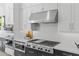 Modern kitchen with stainless steel appliances, custom backsplash, and ample countertop space for meal preparation at 3890 E Andalusia Ave, Gilbert, AZ 85298