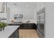 Well-appointed kitchen showcases a large island, black and white cabinetry, and a stainless steel refrigerator at 3890 E Andalusia Ave, Gilbert, AZ 85298