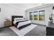 Spacious main bedroom with natural light from three windows and modern furnishings at 3890 E Andalusia Ave, Gilbert, AZ 85298