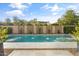Inviting pool with water features, stone decking, and lush plantings, creating a backyard oasis at 3890 E Andalusia Ave, Gilbert, AZ 85298