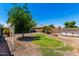 Large backyard features a small patch of grass, desert landscaping, and an above ground pool at 40316 W Hopper Dr, Maricopa, AZ 85138