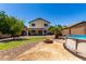 The backyard features a fire pit, above ground pool, desert landscaping and patio at 40316 W Hopper Dr, Maricopa, AZ 85138