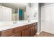 Bright bathroom features a dual sink vanity, mirror and shower with modern fixtures at 40316 W Hopper Dr, Maricopa, AZ 85138
