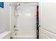 Full tub and shower combo featuring a white shower stall and a colorful superhero shower curtain at 40316 W Hopper Dr, Maricopa, AZ 85138