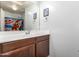 Bathroom with a wooden vanity, a large mirror, and superhero-themed accents in the shower at 40316 W Hopper Dr, Maricopa, AZ 85138
