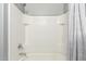 Clean and simple shower tub with white tile and grey curtain at 40316 W Hopper Dr, Maricopa, AZ 85138