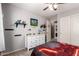Stylish bedroom with a ceiling fan, vibrant gamer decor, and ample natural light for comfortable living at 40316 W Hopper Dr, Maricopa, AZ 85138