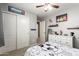 Neutral toned bedroom with soccer-themed bedding and decor with plenty of storage space at 40316 W Hopper Dr, Maricopa, AZ 85138