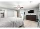 Spacious bedroom features neutral tones, plush carpet, and ample storage with a dresser at 40316 W Hopper Dr, Maricopa, AZ 85138