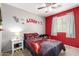 Playful bedroom with gamer accents, colorful walls, and cozy carpeting for a fun, inviting space at 40316 W Hopper Dr, Maricopa, AZ 85138