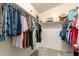 Organized walk-in closet with shelving and hanging space for efficient wardrobe storage at 40316 W Hopper Dr, Maricopa, AZ 85138