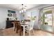 The dining room has a modern chandelier, stylish decor and an adjacent sliding glass door at 40316 W Hopper Dr, Maricopa, AZ 85138