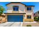 Charming two-story home with a blue garage door, well-maintained lawn, and beautiful curb appeal at 40316 W Hopper Dr, Maricopa, AZ 85138