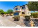Attractive two-story home with a well-manicured front yard, a blue garage door, and inviting curb appeal at 40316 W Hopper Dr, Maricopa, AZ 85138