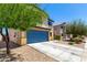 Two-story home with a spacious driveway and a well-maintained front yard with desert landscaping at 40316 W Hopper Dr, Maricopa, AZ 85138