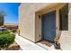 Inviting front entrance with a blue door, decorative plants, and a cozy welcome mat at 40316 W Hopper Dr, Maricopa, AZ 85138