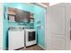 Well-organized laundry room featuring modern appliances and stylish storage solutions with bright walls at 40316 W Hopper Dr, Maricopa, AZ 85138