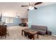 Expansive living room with high ceilings, neutral carpet, and a mix of modern and traditional furniture at 40316 W Hopper Dr, Maricopa, AZ 85138