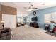 Large, open living room with carpet, high ceilings, and plenty of natural light from the windows at 40316 W Hopper Dr, Maricopa, AZ 85138