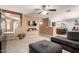 Comfortable living room with a large gray sectional sofa, ceiling fan, and stairway at 40316 W Hopper Dr, Maricopa, AZ 85138