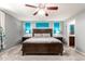 Relaxing primary bedroom with calming blue walls, stylish lamps, and neutral furnishings at 40316 W Hopper Dr, Maricopa, AZ 85138
