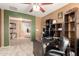Home office offers a functional desk, storage shelving, and view of the stairway at 40316 W Hopper Dr, Maricopa, AZ 85138