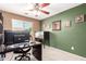 Bright home office space with ample natural light, a desk, and decorative elements for a comfortable work environment at 40316 W Hopper Dr, Maricopa, AZ 85138