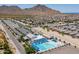 Aerial view of the community pool, clubhouse, and mountain views at 4067 W Maggie Dr, San Tan Valley, AZ 85144