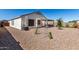Large backyard with rock landscaping, and a covered patio area perfect for relaxing at 4067 W Maggie Dr, San Tan Valley, AZ 85144