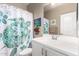 Bright bathroom with white vanity, decorative shower curtain, and ample mirror space at 4067 W Maggie Dr, San Tan Valley, AZ 85144