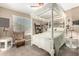 Serene bedroom with a canopy bed, cozy chair, and neutral decor for a relaxing retreat at 4067 W Maggie Dr, San Tan Valley, AZ 85144