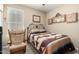 Cozy bedroom features a comfortable bed, chair, and decorative wall art at 4067 W Maggie Dr, San Tan Valley, AZ 85144