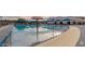 Zero-entry pool area with colorful mushroom water feature and shaded seating, perfect for Gathering fun at 4067 W Maggie Dr, San Tan Valley, AZ 85144