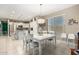 Open-concept dining area with white table and chairs, flowing into the kitchen for easy entertaining at 4067 W Maggie Dr, San Tan Valley, AZ 85144
