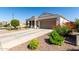 Attractive single-story home with a well-maintained yard and a spacious driveway leading to a two-car garage at 4067 W Maggie Dr, San Tan Valley, AZ 85144