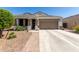Charming single-story home featuring a well-manicured front yard and inviting covered porch at 4067 W Maggie Dr, San Tan Valley, AZ 85144