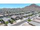 Aerial view of a neighborhood with mountain views and well-maintained streets and landscaping at 4455 W Suncup Dr, San Tan Valley, AZ 85144