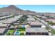 Aerial view of a neighborhood with mountain views, showcasing the home's pool and outdoor space at 4455 W Suncup Dr, San Tan Valley, AZ 85144