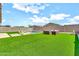 A spacious backyard featuring a pool, seating and artificial turf for easy maintenance at 4455 W Suncup Dr, San Tan Valley, AZ 85144