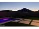 Backyard pool and patio illuminated with a mountain view, great for evening enjoyment at 4455 W Suncup Dr, San Tan Valley, AZ 85144