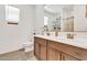 Bright bathroom features a double sink vanity with bronze fixtures and a toilet at 4455 W Suncup Dr, San Tan Valley, AZ 85144