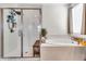 Well-lit bathroom with a separate shower, bathtub, and modern fixtures for a spa-like retreat at 4455 W Suncup Dr, San Tan Valley, AZ 85144